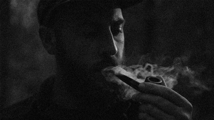 Man smoking marijuana out of a hand pipe