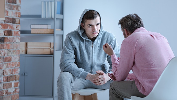 An employer speaks to an employee about addiction in the workplace protocols