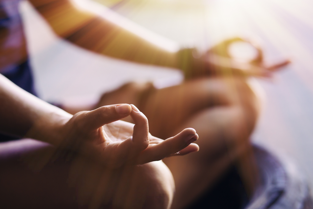Close up of hands of a person meditating
