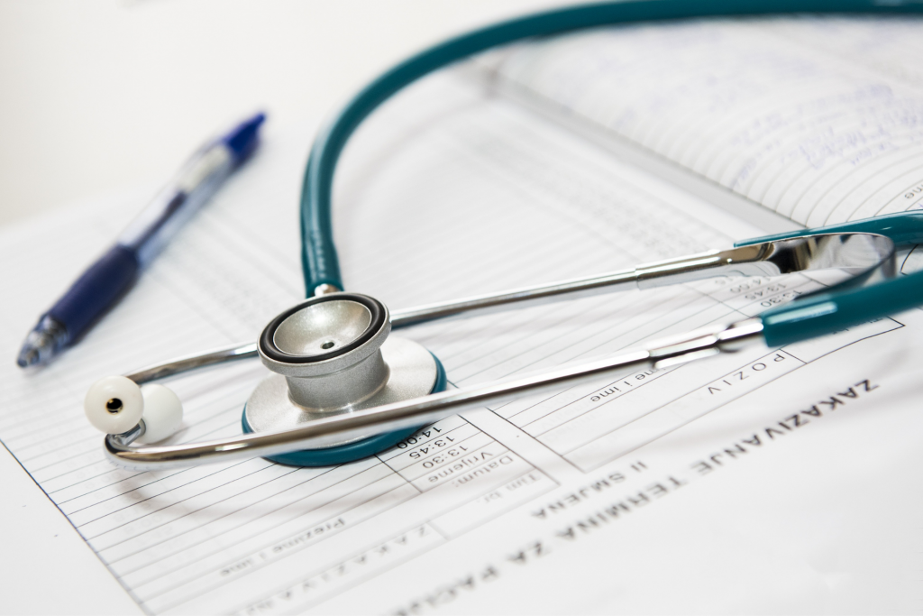 CLose up of a stethoscope and prescription pad 