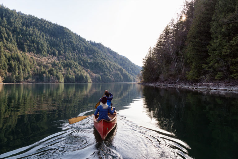 Friends enjoying canoeing in Canada.