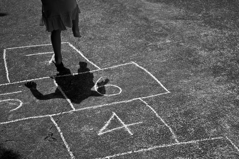 a child playing hopscotch