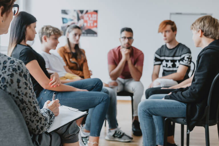 a group therapy session with teenagers
