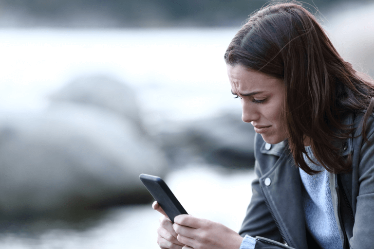 a woman finding a therapist on her phone 