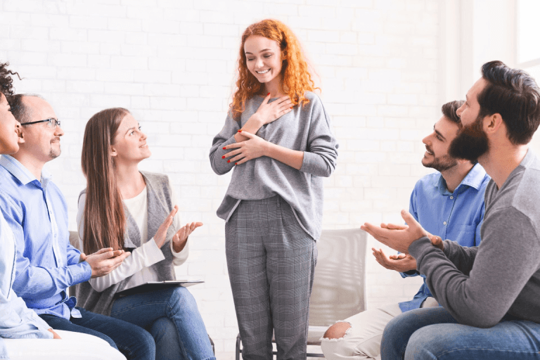 Six people in a group therapy session. 