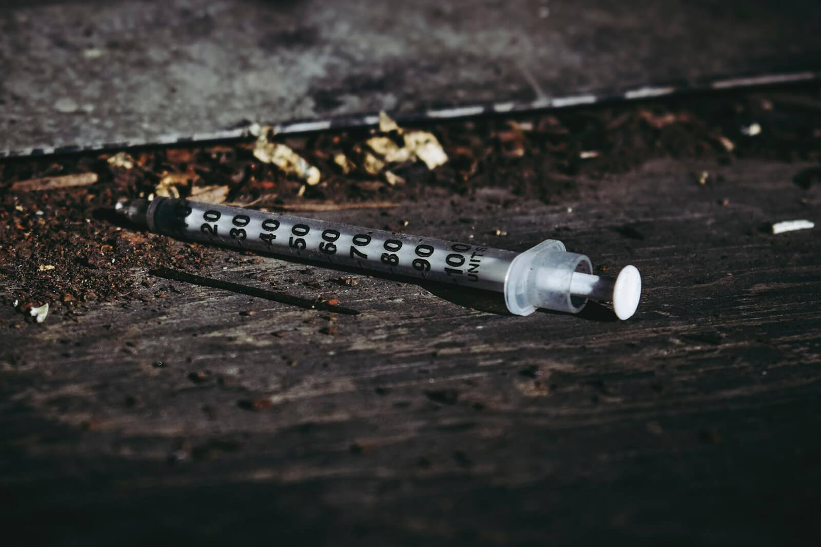 A disposed syringe on the ground