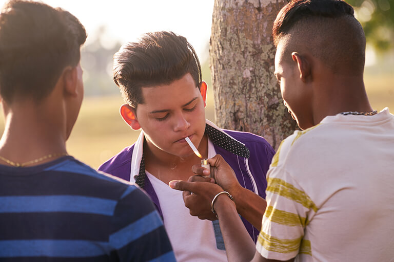 A group of young people smoking
