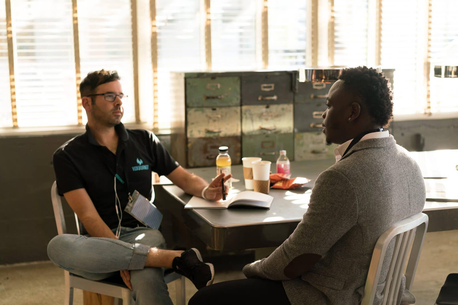 Two men sitting together at a table during a counselling session