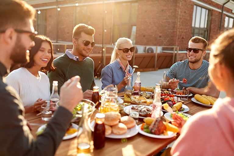 People sitting around a table for a summer barbecue