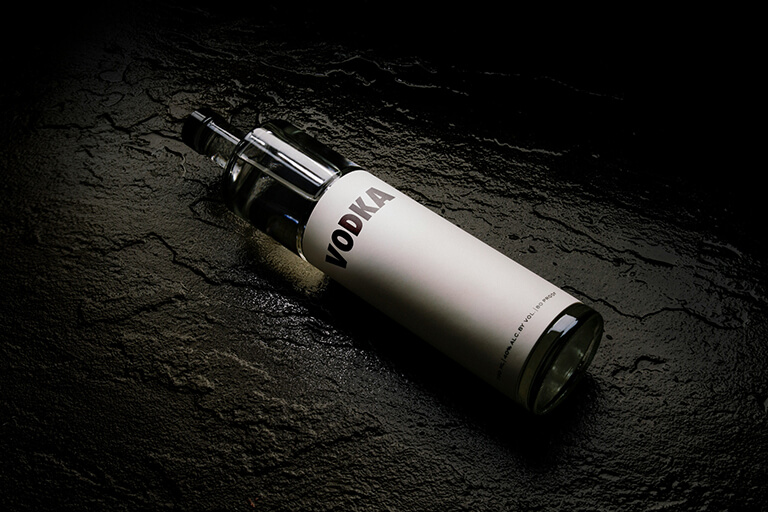 a bottle of vodka in dark lighting
