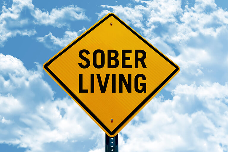 A traffic sign that reads “sober living”