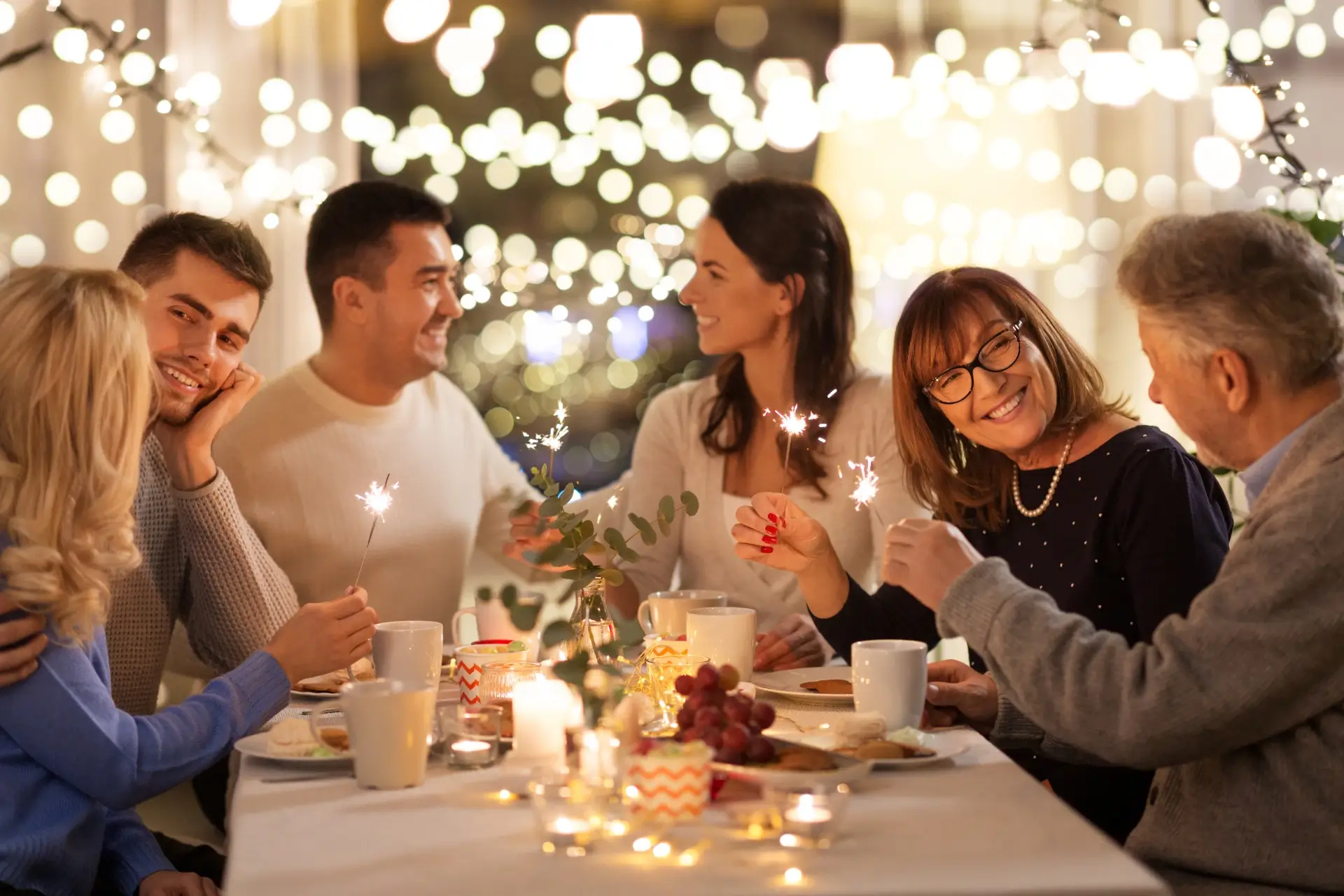  A family celebrates the holidays sitting around a table together
